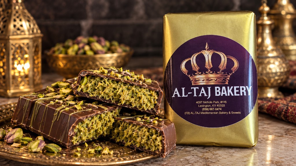 Al-Taj Dubai chocolate bar in gold wrapping, cut to show the pistachio filling